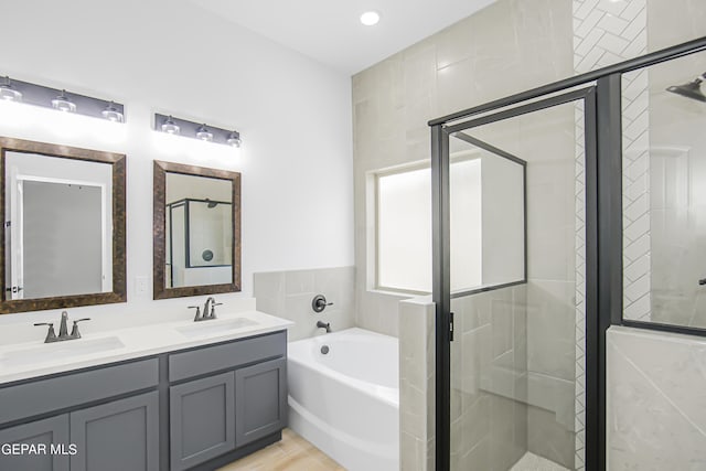 bathroom featuring vanity, wood-type flooring, and independent shower and bath