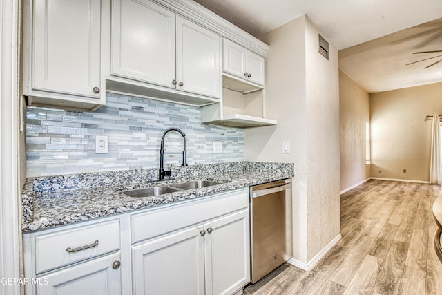 kitchen with light hardwood / wood-style floors, decorative backsplash, dishwasher, white cabinets, and sink