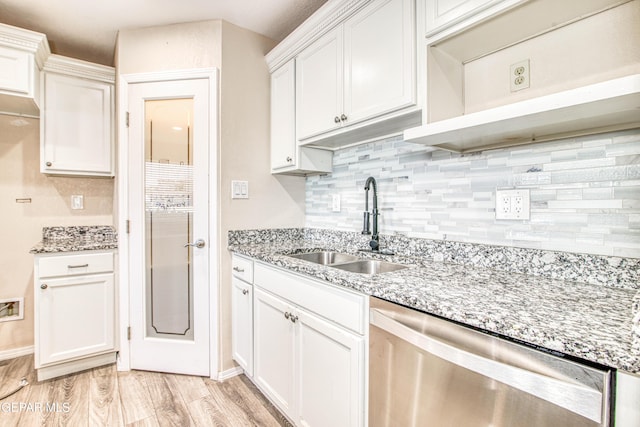 kitchen featuring stainless steel dishwasher, sink, light hardwood / wood-style flooring, white cabinets, and light stone counters