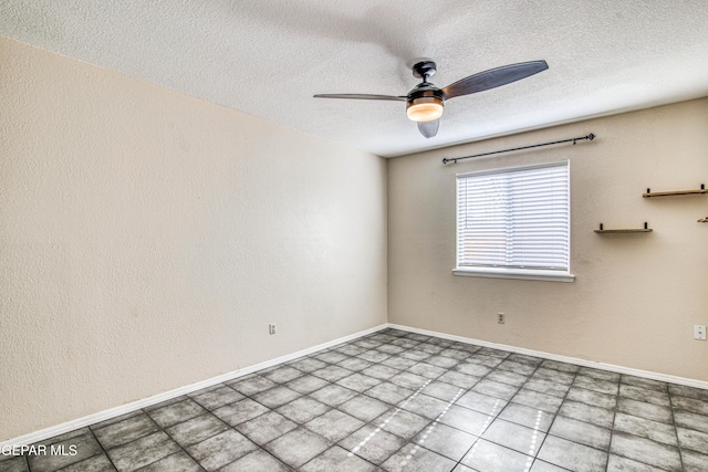 spare room featuring ceiling fan and a textured ceiling