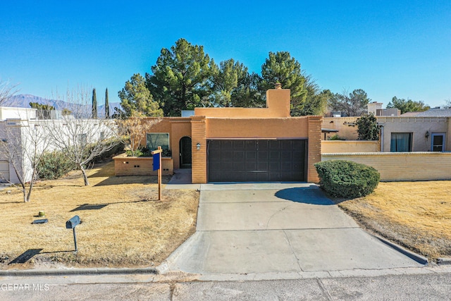 pueblo-style home with a garage