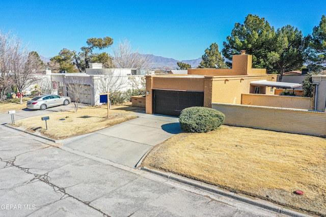 view of front of home with a mountain view and a garage