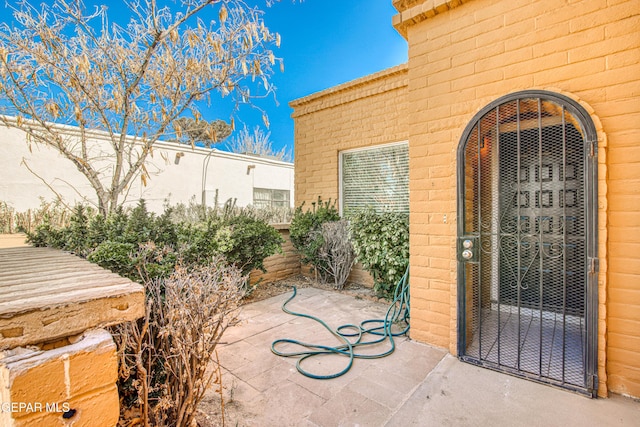 entrance to property featuring a patio