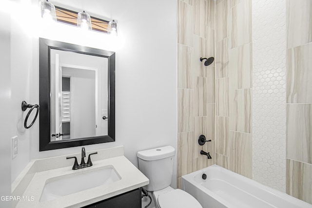 full bathroom featuring vanity, tiled shower / bath combo, and toilet