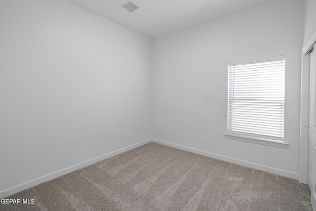 spare room with light colored carpet