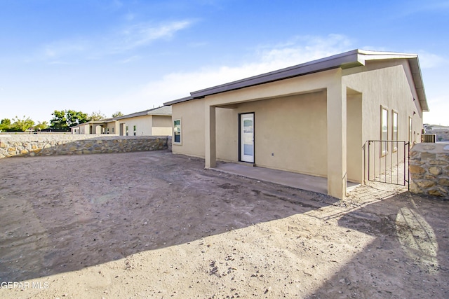 back of property with a patio