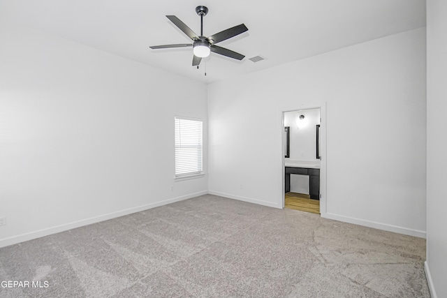 carpeted spare room featuring ceiling fan