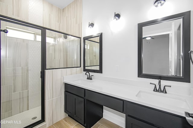 bathroom featuring vanity and an enclosed shower