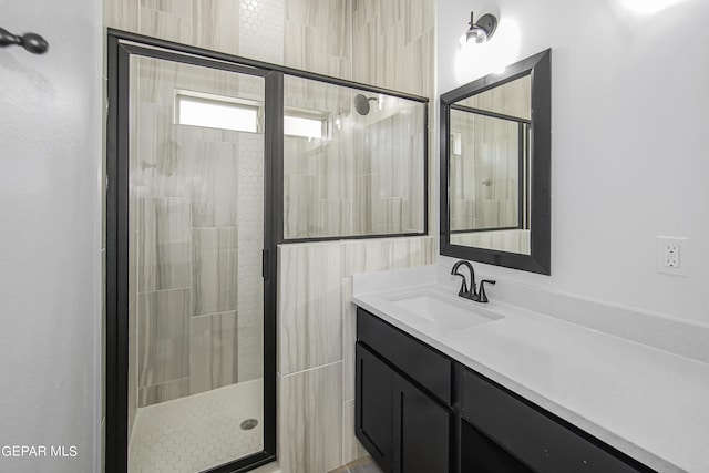 bathroom with walk in shower and vanity