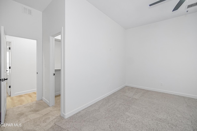 interior space featuring ceiling fan and light carpet