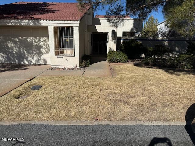 exterior space with a garage and a yard