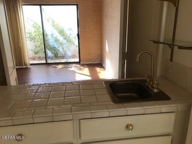 kitchen featuring sink and tile countertops