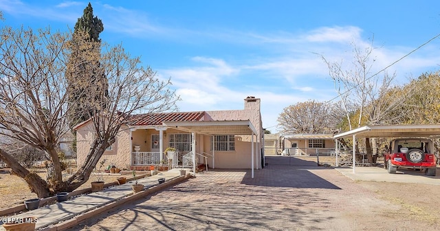 view of front of house with a porch and a carport