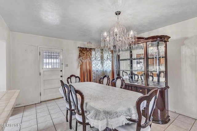 tiled dining area featuring a notable chandelier