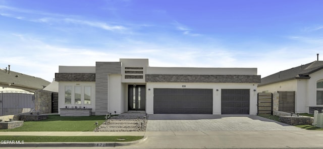 view of front of property featuring central AC and a garage