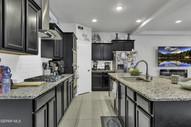 kitchen featuring sink, wall chimney exhaust hood, light tile patterned floors, light stone countertops, and stainless steel appliances