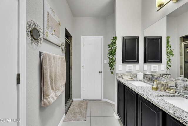 bathroom with an enclosed shower, tile patterned floors, and vanity