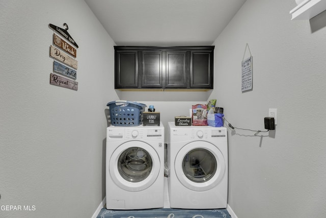 washroom with cabinets and washer and clothes dryer