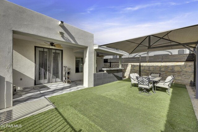 view of yard featuring ceiling fan and a patio area