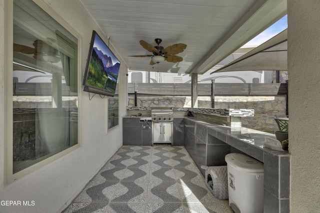 exterior space with area for grilling, a grill, and ceiling fan