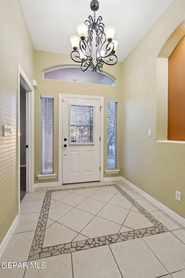 tiled entryway with an inviting chandelier