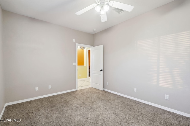 spare room featuring ceiling fan and carpet floors