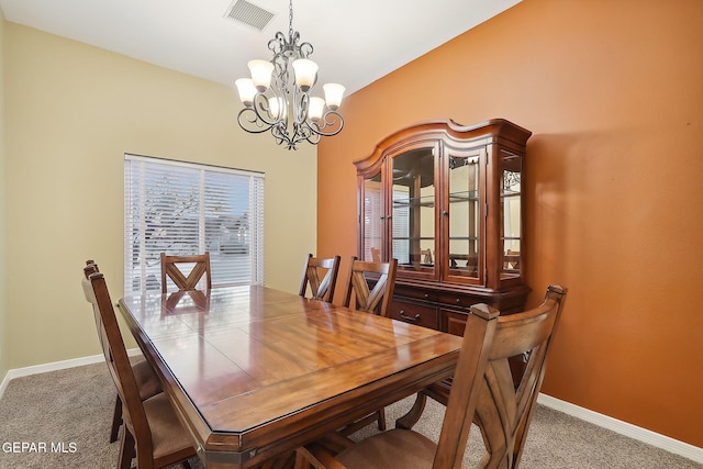 dining area featuring light carpet and an inviting chandelier