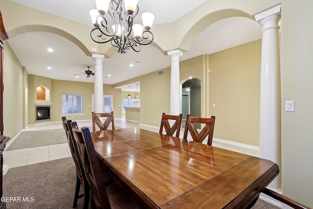 tiled dining area with ceiling fan and ornate columns