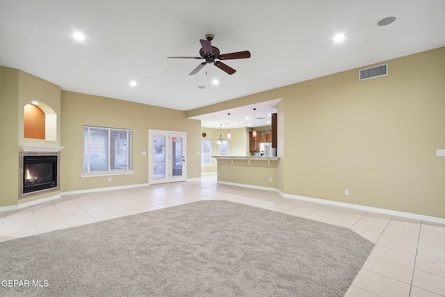 unfurnished living room with ceiling fan and light tile patterned floors