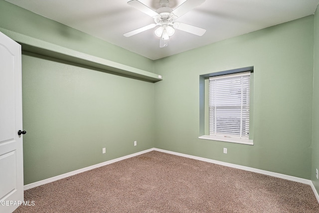 empty room featuring ceiling fan and carpet flooring