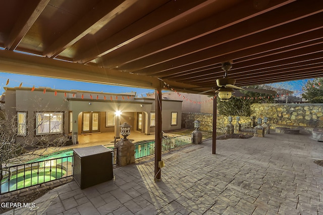 view of patio / terrace with ceiling fan and a fenced in pool