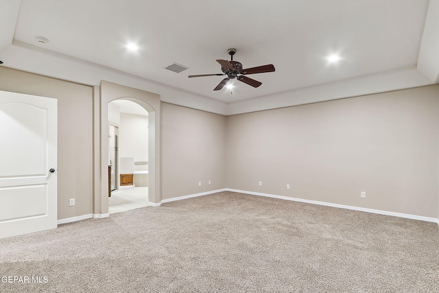 empty room featuring ceiling fan and light carpet