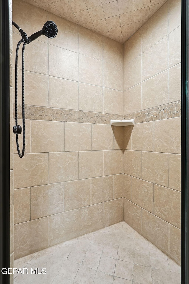 bathroom with tiled shower