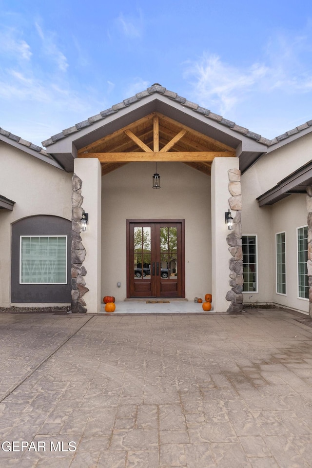 entrance to property with french doors and a patio