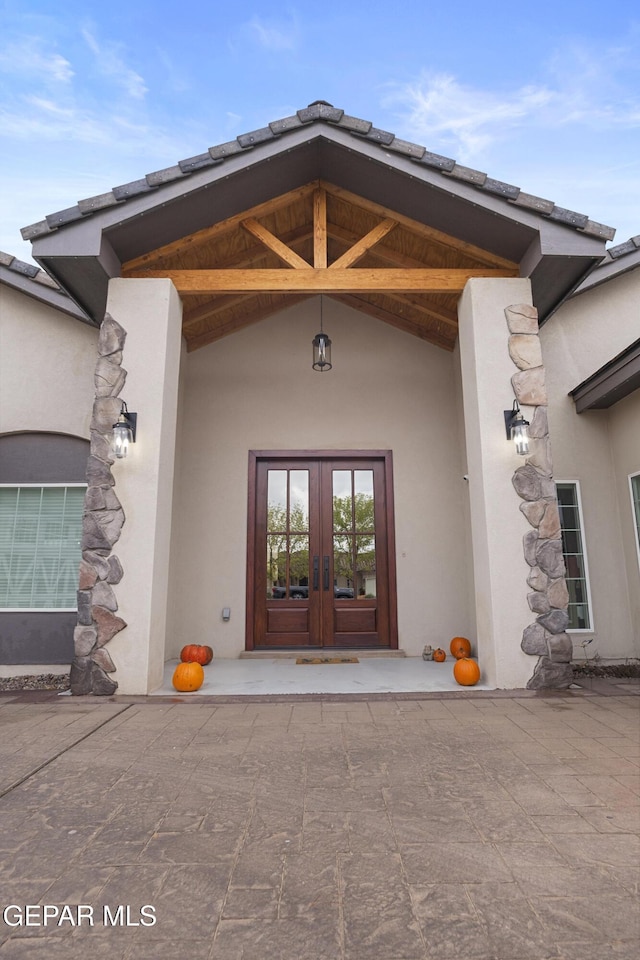 view of exterior entry featuring french doors