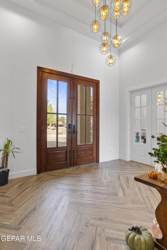 entryway featuring french doors and light parquet flooring