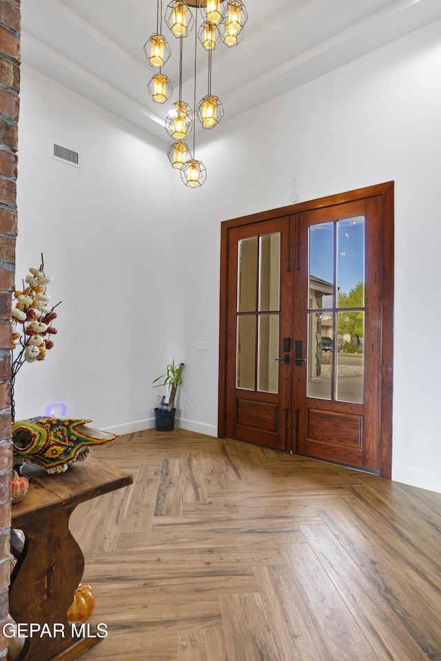 foyer entrance with french doors and parquet floors