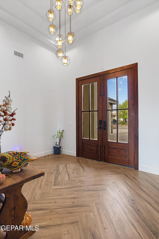 interior space with french doors and light parquet flooring