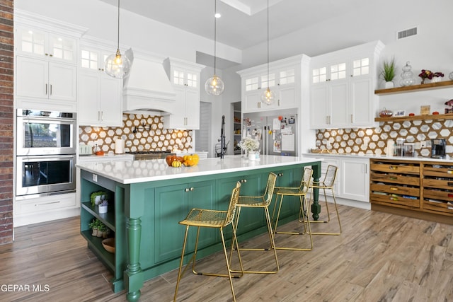 kitchen featuring white cabinetry, backsplash, and custom range hood