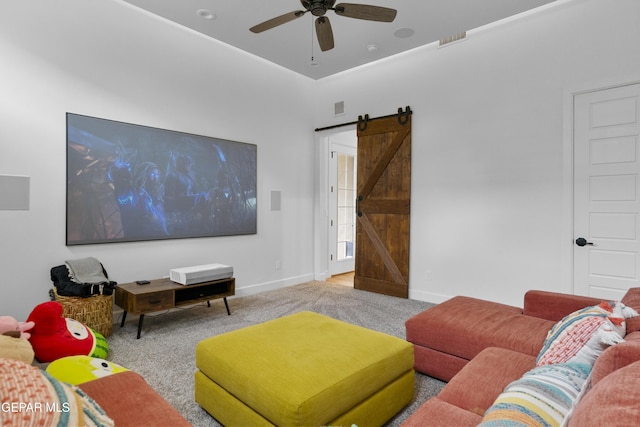 living room featuring light carpet, ceiling fan, and a barn door