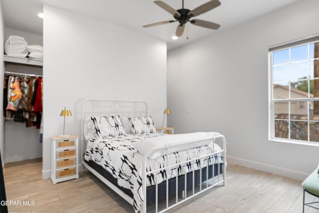 bedroom with ceiling fan and hardwood / wood-style floors