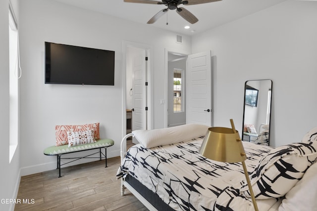 bedroom with ceiling fan and light hardwood / wood-style flooring