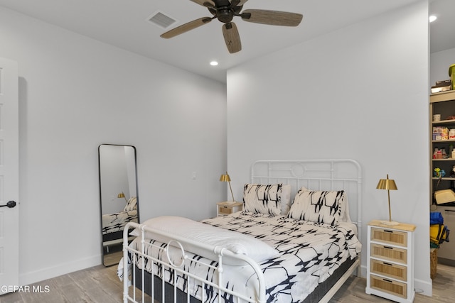 bedroom with light hardwood / wood-style floors and ceiling fan