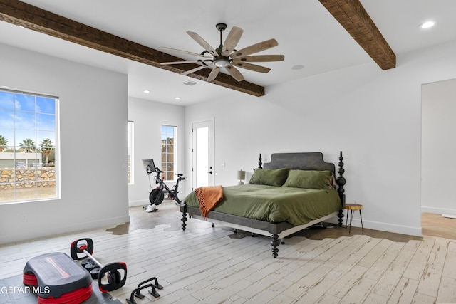 bedroom featuring light wood-type flooring, ceiling fan, beamed ceiling, and multiple windows