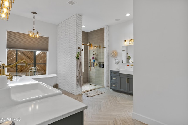 bathroom featuring parquet flooring, a shower with door, a notable chandelier, and vanity