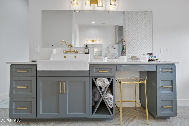 bathroom featuring parquet flooring and vanity