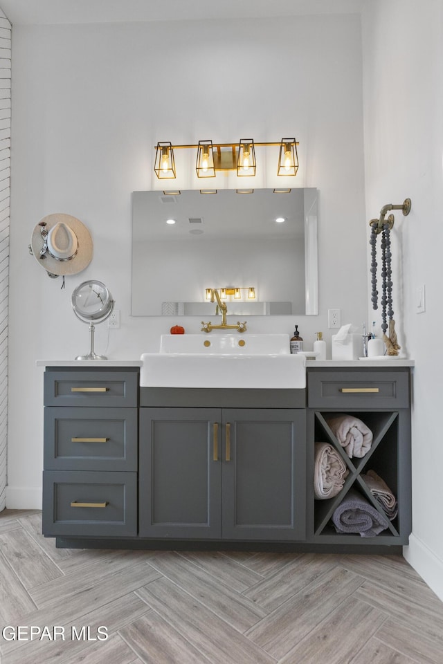 bathroom featuring parquet flooring and vanity