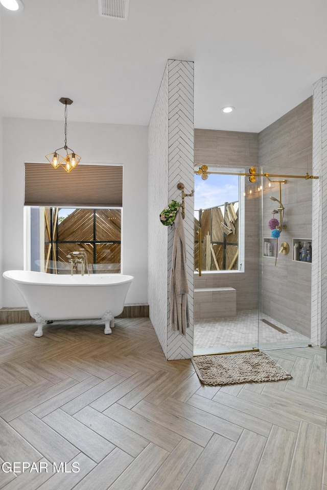 bathroom featuring an inviting chandelier, separate shower and tub, and parquet flooring