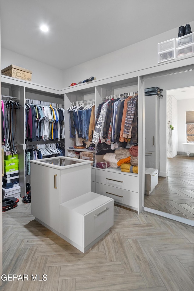 walk in closet featuring light parquet floors