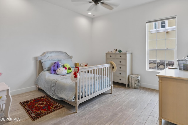 bedroom with light wood-type flooring and ceiling fan